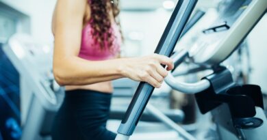Close up of hands of a fit woman in the gym, exercising legs doing cardio workout
