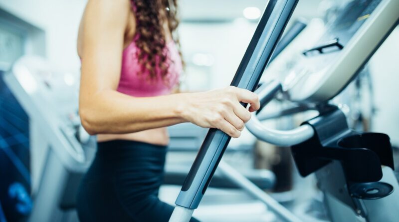 Close up of hands of a fit woman in the gym, exercising legs doing cardio workout