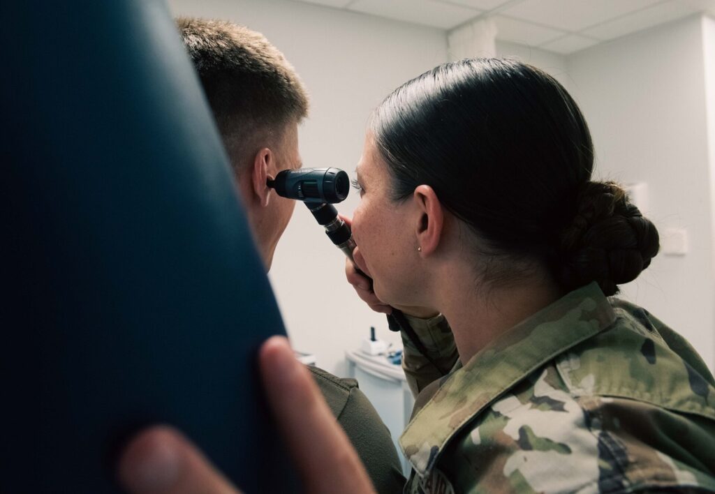 U.S. Airman 1st Class Ashley Polk, 86th Operational Medical Readiness Squadron warrior medicine medical technician, performs an ear inspection at Rams